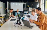 Tech workers collaborating in an open-office environment.