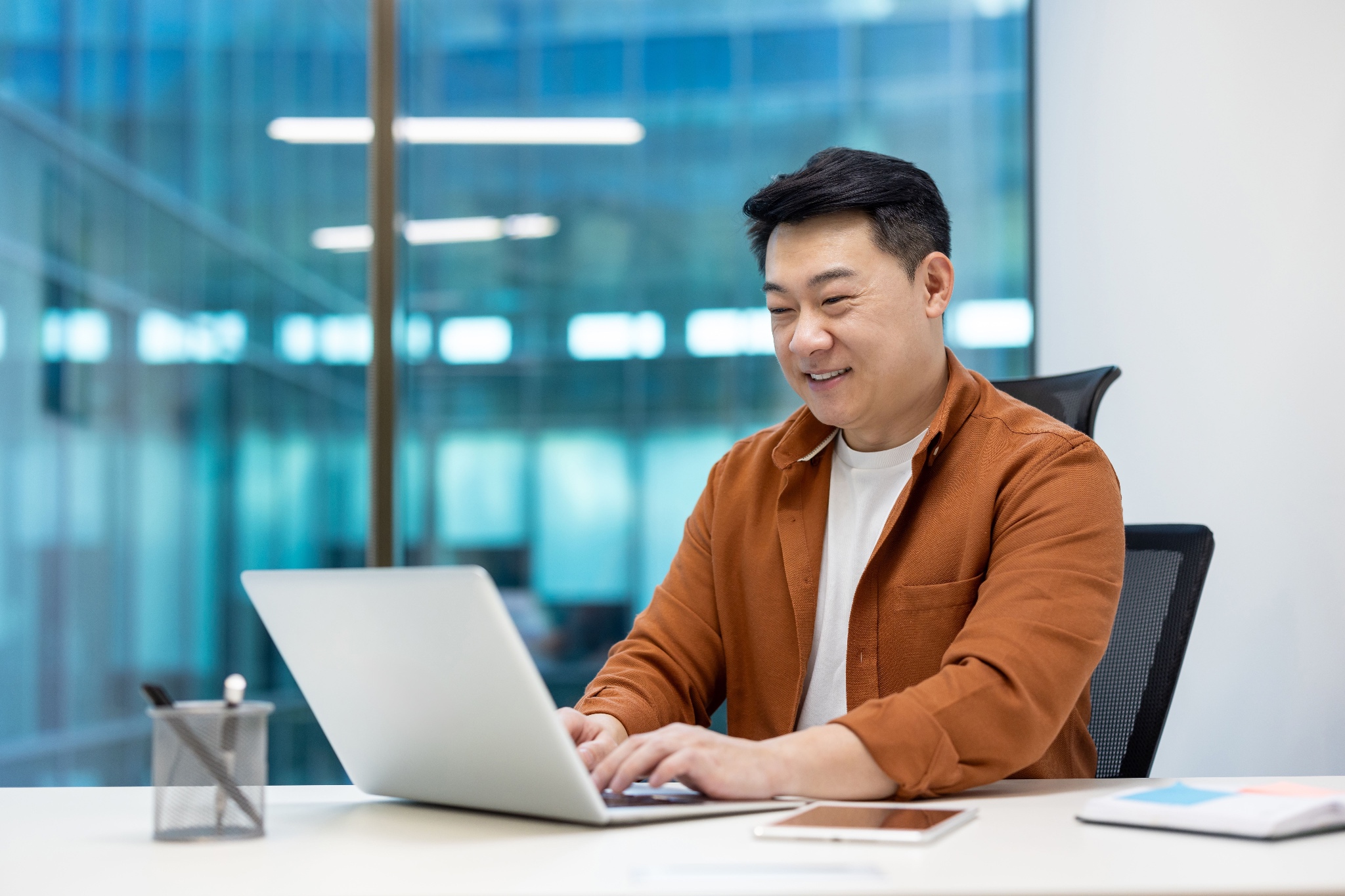 Customer using a laptop in a conference room. Customer training.